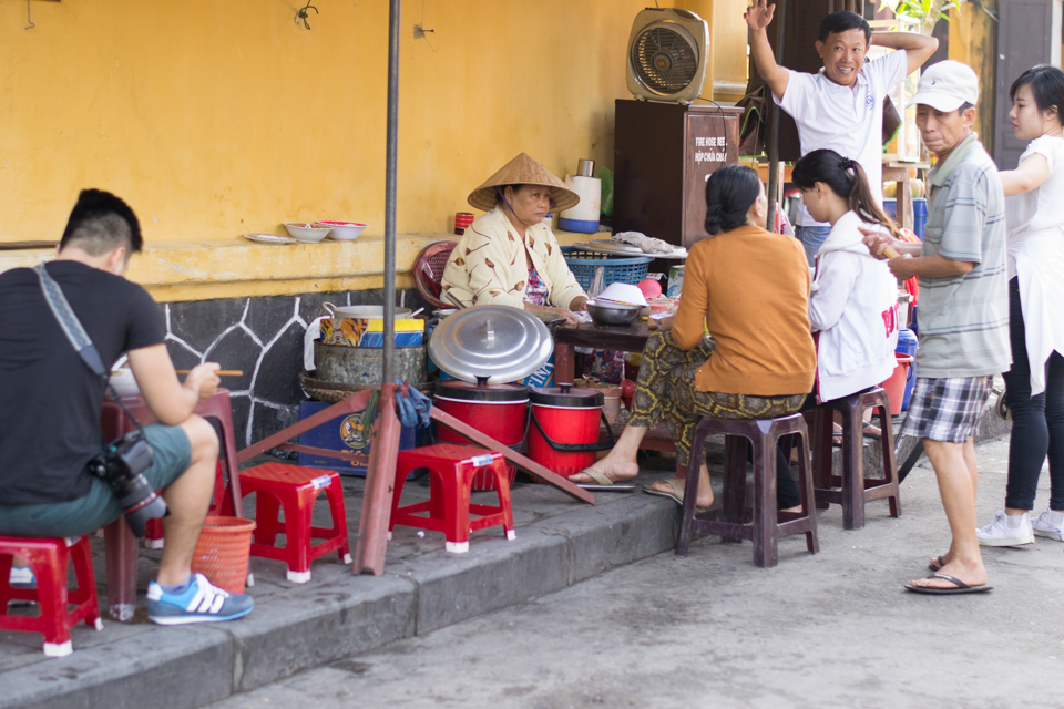 Vietnamese patrons having their morning breakfast outside 