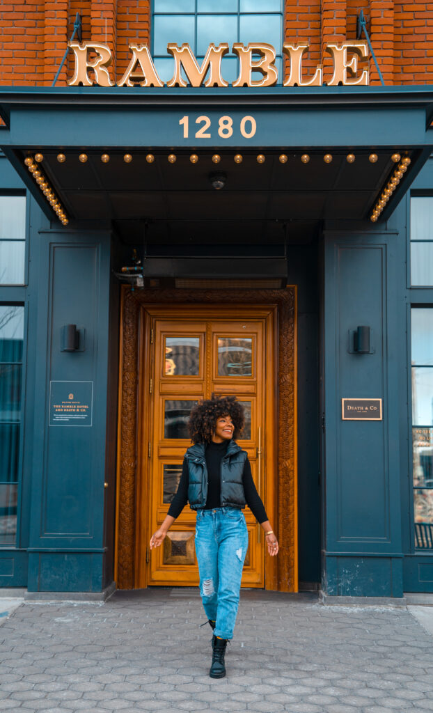 Black travel blogger in front of luxury hotel The Ramble Hotel in Denver, Colorado